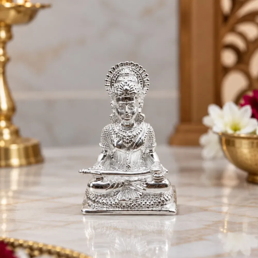 Bring a sense of divine grace to your sacred space with this beautifully crafted Annapurna Maa Silver Murti, made in 925 Sterling Silver and designed as a solid silver murti. The idol beautifully depicts Maa Annapurna seated gracefully in a traditional posture, holding a finely detailed ladle and vessel, symbolizing nourishment and abundance. Intricate detailing on her crown, jewellery, attire, facial features, and the richly patterned pedestal showcases exquisite Indian craftsmanship. The polished silver finish enhances its elegant appearance and f